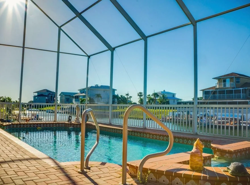 A screened backyard pool on a sunny day